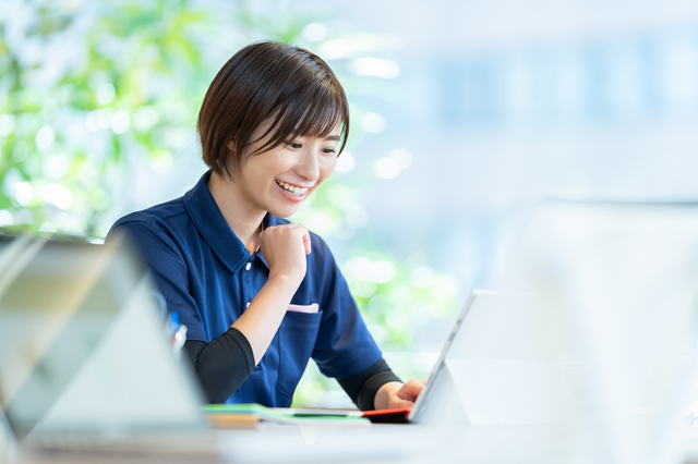 笑顔でPCを操作する女性